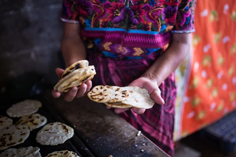 lady holding hand made tortillas